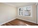 Bedroom features hardwood floors, neutral walls, and a window with decorative bars at 441 Windsor Dr, Forest Park, GA 30297