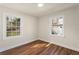 Bedroom featuring hardwood floors, white trim and two windows letting in natural light at 441 Windsor Dr, Forest Park, GA 30297