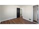 Image shows a bedroom with a door, closet, hardwood floors and white trim at 441 Windsor Dr, Forest Park, GA 30297
