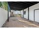 Covered carport with brick flooring and a view of the detached garage or shed on property at 441 Windsor Dr, Forest Park, GA 30297