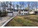 Charming home with an attached garage, second story deck and inviting curb appeal at 441 Windsor Dr, Forest Park, GA 30297