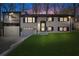 Charming white brick home with black trim and a spacious front yard at dusk at 441 Windsor Dr, Forest Park, GA 30297
