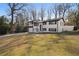 Spacious front yard with a well-maintained lawn, mature trees, and a charming two-story home at 441 Windsor Dr, Forest Park, GA 30297