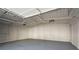 Spacious, empty garage interior with lighting, concrete floor, and ample room for vehicles or storage at 441 Windsor Dr, Forest Park, GA 30297