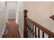 Hallway with wood floors and access to bedrooms and bathrooms at 441 Windsor Dr, Forest Park, GA 30297