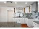 Modern kitchen featuring granite countertops, white cabinets, and a stylish backsplash at 441 Windsor Dr, Forest Park, GA 30297