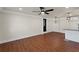 Living room featuring wood floors, ceiling fan, entry door and access to modern kitchen at 441 Windsor Dr, Forest Park, GA 30297