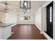 Bright living room with wood floors, ceiling fan and view into modern entry door at 441 Windsor Dr, Forest Park, GA 30297