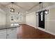 Living room with ceiling fan, recessed lights, new window and access to modern kitchen at 441 Windsor Dr, Forest Park, GA 30297