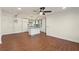 Open living room with access to the eat-in kitchen features attractive wood flooring at 441 Windsor Dr, Forest Park, GA 30297