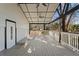 Large, covered back porch featuring white railings, ceiling fans and views of the yard at 441 Windsor Dr, Forest Park, GA 30297