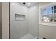 Beautiful marble tiled shower with a rain shower head and built-in niche at 441 Windsor Dr, Forest Park, GA 30297