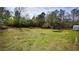 Extensive green backyard space with trees and vegetation and a shed for storage at 70 Woodcliff Way, Covington, GA 30014
