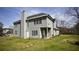 Beautiful view of backyard showing the home's back elevation, patio, and generous yard space at 70 Woodcliff Way, Covington, GA 30014