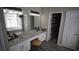 Elegant bathroom featuring double sinks with granite countertops, complemented by modern fixtures and ample lighting at 70 Woodcliff Way, Covington, GA 30014