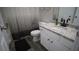 Cozy bathroom featuring a granite countertop, white vanity, and modern fixtures at 70 Woodcliff Way, Covington, GA 30014