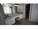 Elegant bathroom featuring double sinks with granite countertops, complemented by modern fixtures and ample lighting at 70 Woodcliff Way, Covington, GA 30014