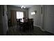 Dining room features a wood table with seating for six, chandelier and gray wood-look floors at 70 Woodcliff Way, Covington, GA 30014