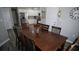 Dining room features a wood table with seating for six, stainless steel refrigerator and gray wood-look floors at 70 Woodcliff Way, Covington, GA 30014
