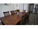 Dining room features a wood table with seating for six, stainless steel refrigerator and gray wood-look floors at 70 Woodcliff Way, Covington, GA 30014