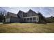 Charming two-story home features a welcoming front porch and an attached two-car garage at 70 Woodcliff Way, Covington, GA 30014