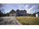 Exterior view of a two-story home with a two-car garage and a long driveway at 70 Woodcliff Way, Covington, GA 30014