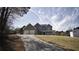 Two-story home on a sloped lot, featuring an attached two-car garage and covered front porch at 70 Woodcliff Way, Covington, GA 30014