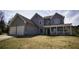 Traditional two-story home with a two-car garage, covered porch, and well-maintained lawn at 70 Woodcliff Way, Covington, GA 30014
