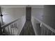 Well-lit hallway with modern railings and beautiful laminate flooring, leading to other rooms at 70 Woodcliff Way, Covington, GA 30014