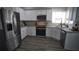 Bright kitchen features white cabinets, granite countertops and stainless steel appliances at 70 Woodcliff Way, Covington, GA 30014