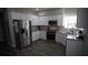 Bright kitchen features white cabinets, granite countertops and stainless steel appliances at 70 Woodcliff Way, Covington, GA 30014