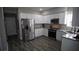 Bright kitchen features white cabinets, granite countertops and stainless steel appliances at 70 Woodcliff Way, Covington, GA 30014