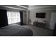 A comfortable main bedroom with a large window, TV, and convenient ensuite bathroom access at 70 Woodcliff Way, Covington, GA 30014