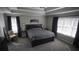 A main bedroom with natural light, a tray ceiling, and large windows create a relaxing atmosphere at 70 Woodcliff Way, Covington, GA 30014