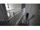 Bright, naturally lit staircase with white railings and modern gray wood-look flooring at 70 Woodcliff Way, Covington, GA 30014