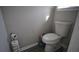 Toilet located in a neutral-toned bathroom; the small space features light walls and is tidy at 70 Woodcliff Way, Covington, GA 30014