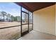 View of the screened back porch and large backyard with some trees in the distance at 803 New Horizon St, Powder Springs, GA 30127