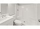 White bathroom with single sink vanity and stand up shower with built in seat at 803 New Horizon St, Powder Springs, GA 30127