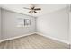 Neutral bedroom with light wood laminate flooring, a ceiling fan and a window at 803 New Horizon St, Powder Springs, GA 30127