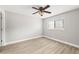 Neutral bedroom with light wood laminate flooring, ceiling fan and a window at 803 New Horizon St, Powder Springs, GA 30127