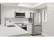 Well-lit kitchen boasting stainless steel appliances, white cabinets, and modern countertops at 803 New Horizon St, Powder Springs, GA 30127