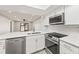 Modern kitchen featuring stainless steel appliances, white cabinetry, and stone countertops at 803 New Horizon St, Powder Springs, GA 30127