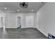 Finished basement with wood floors and recessed lighting, offering versatile space and access to other areas at 1043 Harvest Park Ln, Suwanee, GA 30024