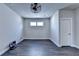 Finished basement features sleek wood floors, recessed lighting and a modern ceiling fan, offering a versatile space at 1043 Harvest Park Ln, Suwanee, GA 30024