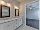 Bright bathroom features double vanity with white cabinets and tile flooring, leading to a bedroom at 1043 Harvest Park Ln, Suwanee, GA 30024