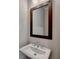 Chic bathroom featuring a pedestal sink and a stylish framed mirror at 1043 Harvest Park Ln, Suwanee, GA 30024