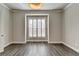 Inviting bedroom with natural light, shuttered windows, and modern light fixture at 1043 Harvest Park Ln, Suwanee, GA 30024