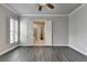 Spacious bedroom with a ceiling fan and hardwood floors that leads to the main bathroom at 1043 Harvest Park Ln, Suwanee, GA 30024