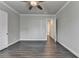 Spacious bedroom with a ceiling fan and hardwood floors that leads to another bedroom at 1043 Harvest Park Ln, Suwanee, GA 30024