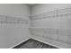 Walk-in closet featuring wire shelving and gray flooring at 1043 Harvest Park Ln, Suwanee, GA 30024